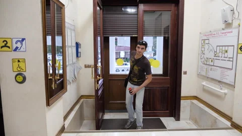 Guy puts coffee cup and fresh flower on reception counter Stock Footage 138636463