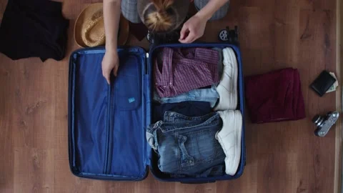 The guy puts the documents, things, a camera and an underwater mask in the Stock Footage 135595383
