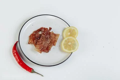 A guy puts dried meat in paper boxes in black gloves Stock Photos