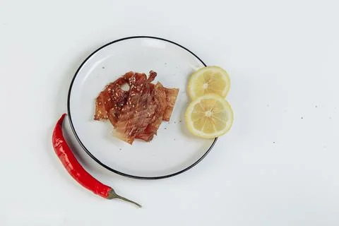 A guy puts dried meat in paper boxes in black gloves Stock Photos