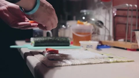 The guy puts the filling for the rolls Stock Footage 143476773