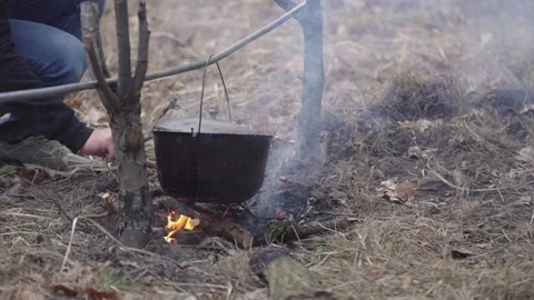 The guy puts firewood on the campfire Stock Footage 234539244