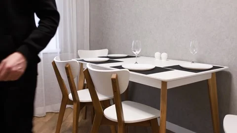 The guy puts the glasses on the table. Stock Footage 231814367