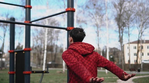 The guy puts hands on the crossbar but changes his mind about doing the exercise Stock Footage 129046004