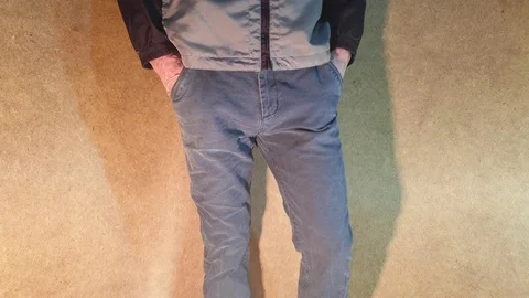 The guy puts his hands in his trouser pockets. Put your hands in your pockets. Stock Footage 101810102