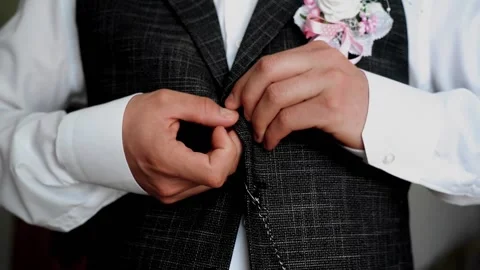 The guy puts on his jacket on the go looking forward. Stylish man Stock Footage 138115237