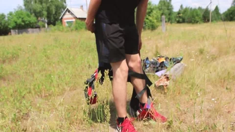 Guy puts on jump gear Stock Footage 130737142