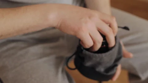 The guy puts the lens into the case Stock Footage 136784400