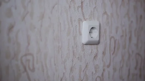 The guy puts in a plug socket Stock Footage 48914190
