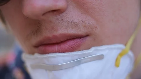 Guy puts on a protective mask, respiratory protective mask, epidemic preventi Stock Footage 125911150