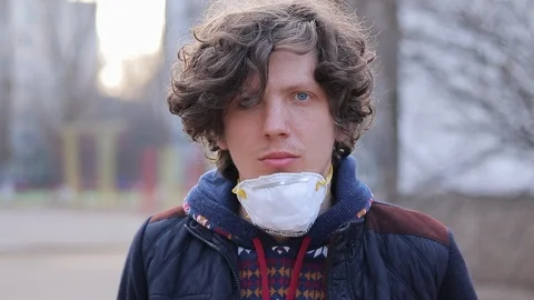 Guy puts on a protective mask, respiratory protective mask, epidemic preventi Stock Footage 125911268