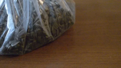 The guy puts the seeds on the table Stock Footage 93496598