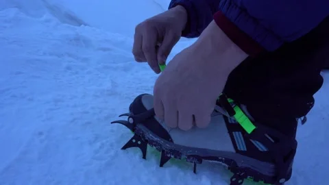 The guy puts spikes on mountain boots. Video stock 171180122