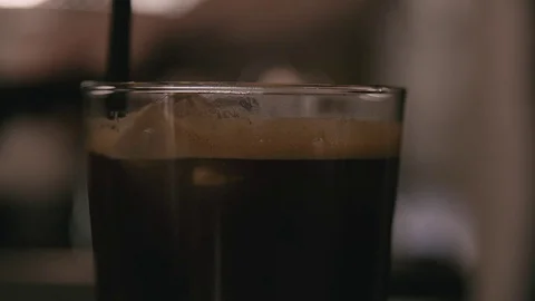 Guy puts a straw in a coffe drink Stock Footage 78031402