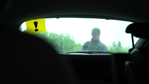 The guy puts things in the trunk of the car Stock Footage 130877814