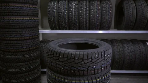The guy puts the tires on top of each other. Stock Footage 82584511