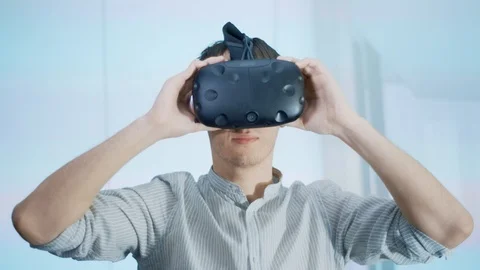 The guy puts on virtual reality glasses and studies the design project, looks Stock Footage 113349236