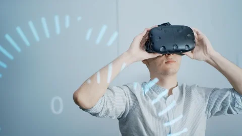 The guy puts on virtual reality glasses and studies the design project, looks Stock Footage 113349338