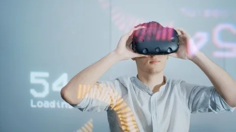 The guy puts on virtual reality glasses and studies the design project, looks Video stock 113349402