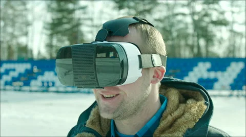 Guy putting on VR glasses at stadium Stock Footage 63607359