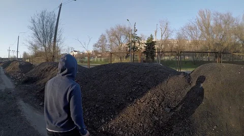  Guy quickly runs against the sky on heaps Stock Footage 127867657