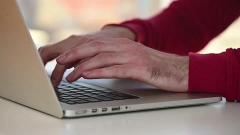 Guy quickly types on laptop keyboard text Stock Footage 143560103