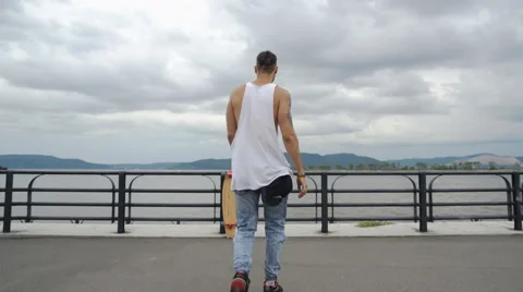 The guy raises his hands to the grey sky Stock Footage 66985479