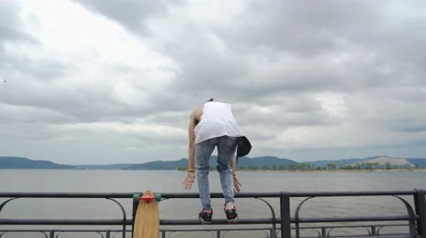 The guy raises his hands to the grey sky Stock Footage 66986236