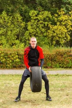 The guy raises the up tire. Stock Photos