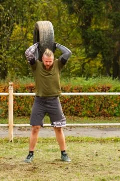 The guy raises the up tire. Stock Photos
