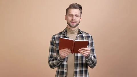 Guy read favorite diary book enjoy memory isolated pastel color background Stock Footage 176787612