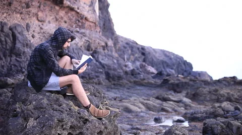 A guy reading a book Stock Footage 58114633