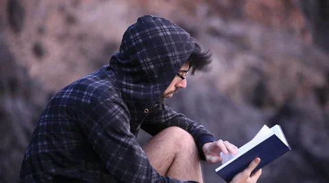 A guy reading a book 스톡 동영상 58115278