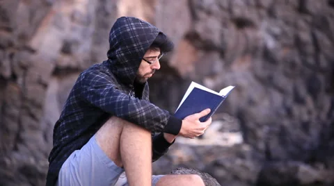 A guy reading a book 스톡 동영상 58115667