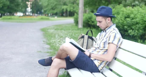 The guy is reading a book in the park. Stock Footage 52453523
