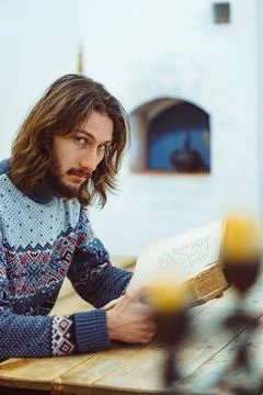 The guy is reading an old book Stock Photos