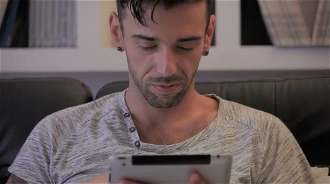 Guy reading on sofa with a tablet Stock Footage 51391568