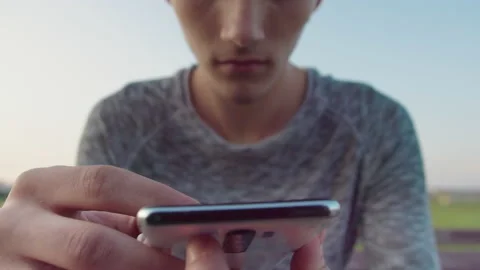 Guy reads text messages on his phone mobile app and smiles, close-up Stock Footage 164321338