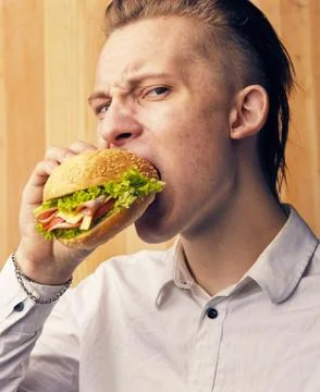 Guy is really trying to burger Stock Photos
