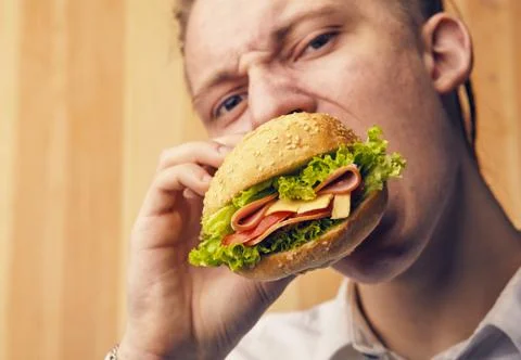 Guy is really trying to burger Stock Photos