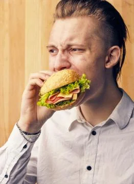 Guy is really trying to burger Stock Photos
