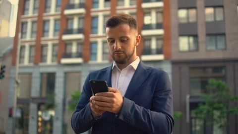Guy receives messages on his cell phone Stock Footage 92059236