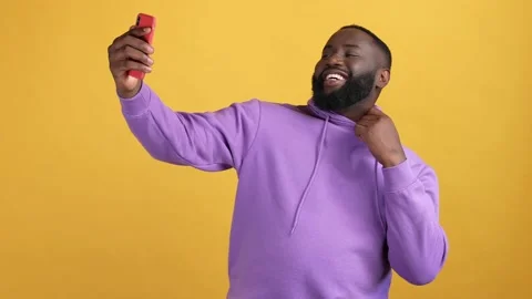 Guy record video device thumb-up v sign isolated vivid color background Video stock 168370552