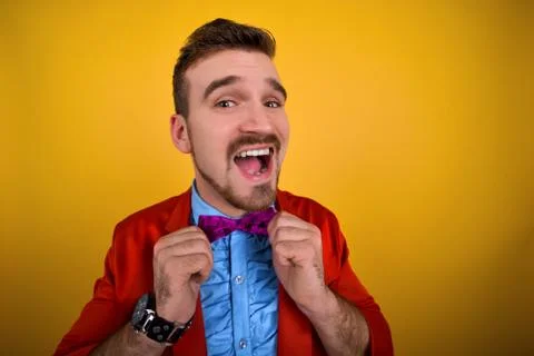 Guy in red jacket corrects tie and smile Stock Photos