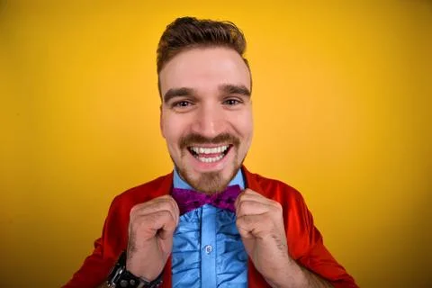 Guy in red jacket corrects tie and smile Stock Photos