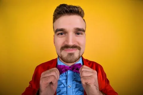 Guy in red jacket corrects tie and smile Stock Photos