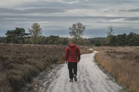 Guy in a red jacket walked on the path Stock Photos