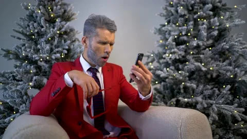 The guy in the red suit shows the phone with a green screen. Stock Footage 167648948
