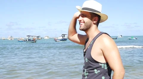 Guy relaxing in Praia do Forte Beach, Bahia, Brazil Stock Footage 62839265