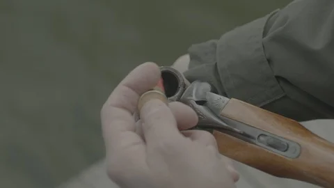 Guy is reloading his shotgun Stock Footage 121661123
